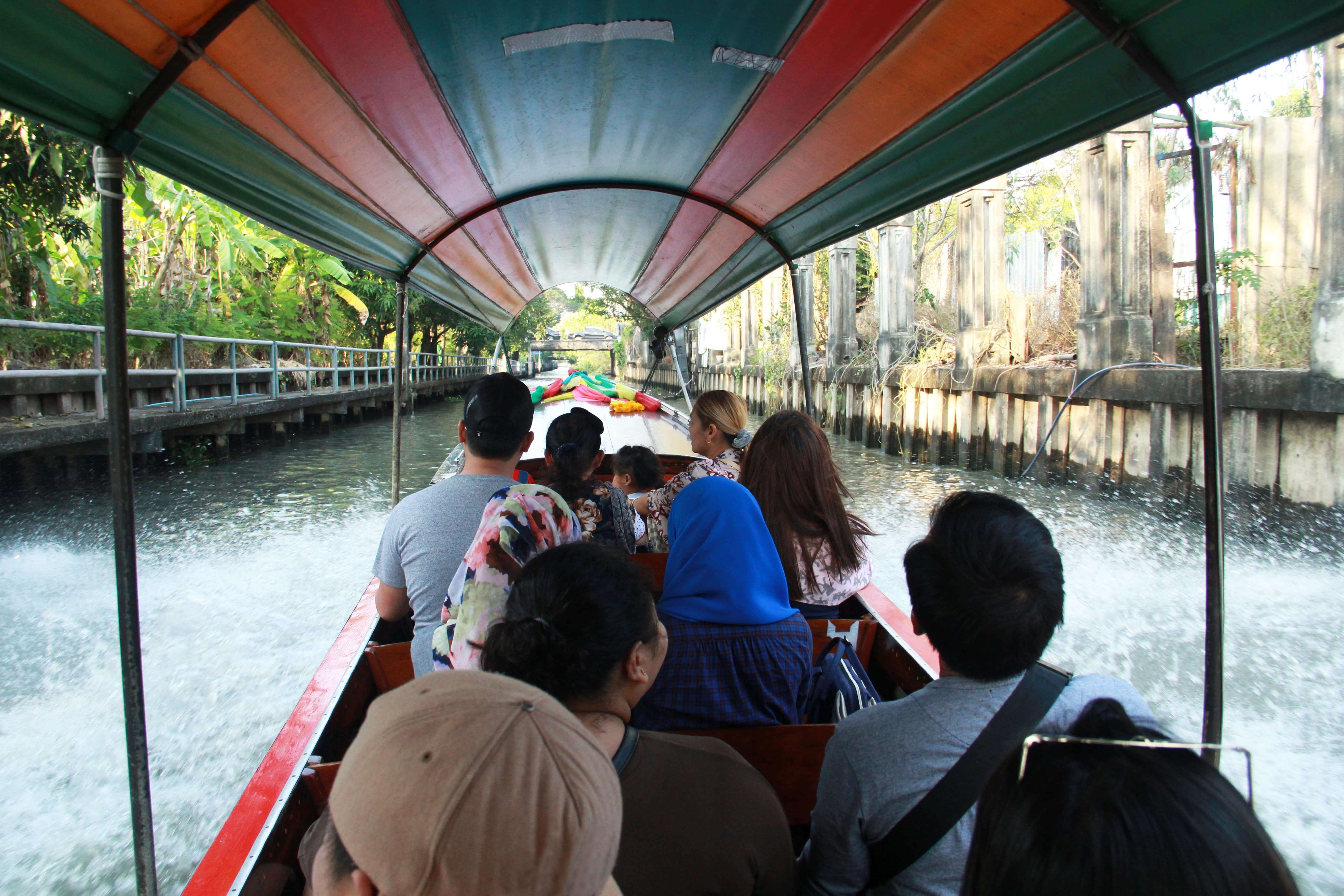 Long tailed boat with passengers sitting for touring canal in Bangkok,Thailand.